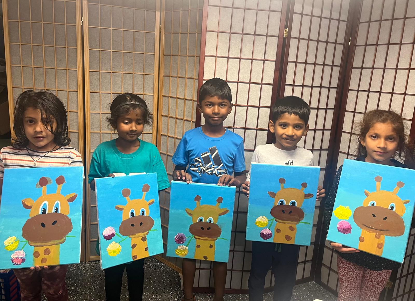 Students showing their artwork